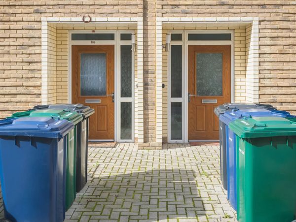 Blue and green bins by white doors
