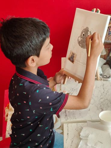 Boy painting on an easel