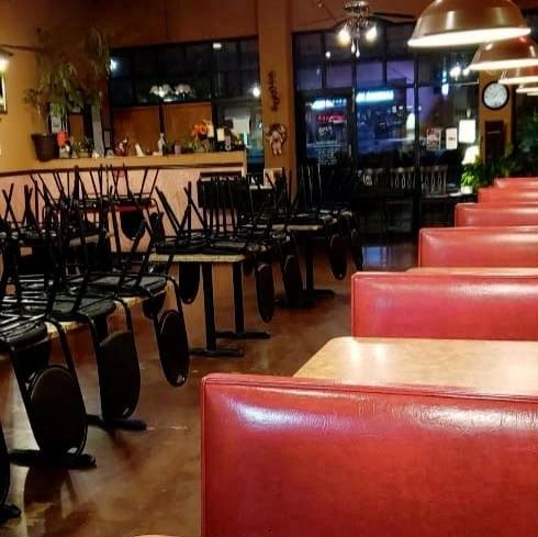Closed down Mexican restaurant with chairs and booths and on top of tables.