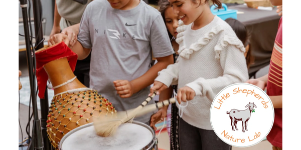 Children joyfully playing drums and percussion instruments together.