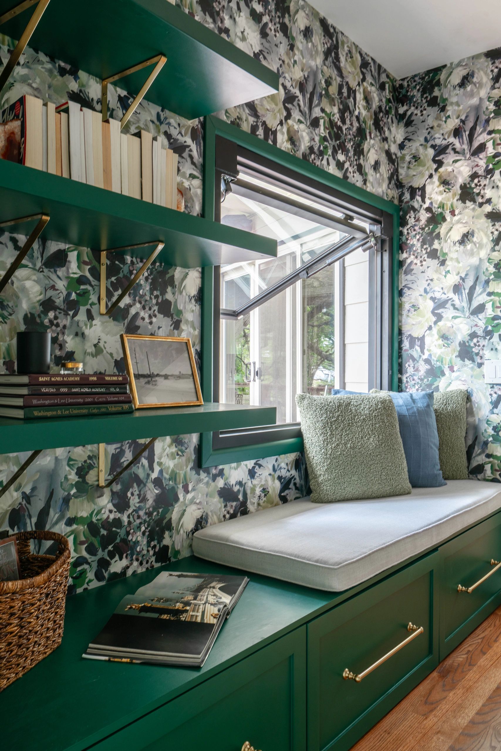 Floral wallpaper reading nook, emerald built-in shelving, cushioned window seat, Austin, TX remodel