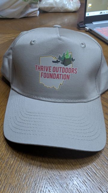 Beige cap with Thrive Outdoors Foundation logo.