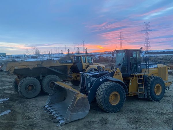 Deere 844 and Volvo Rocktruck working on yard space expansion 