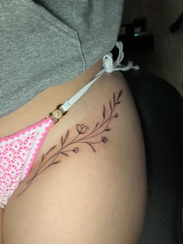 Delicate floral tattoo on hip.