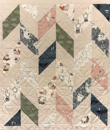 Colorful geometric patchwork quilt with animal patterns.