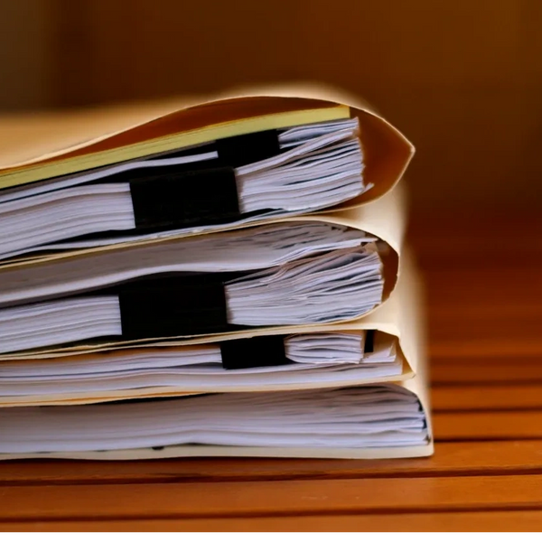 Manila folders filled with documents needing to be notarized. 