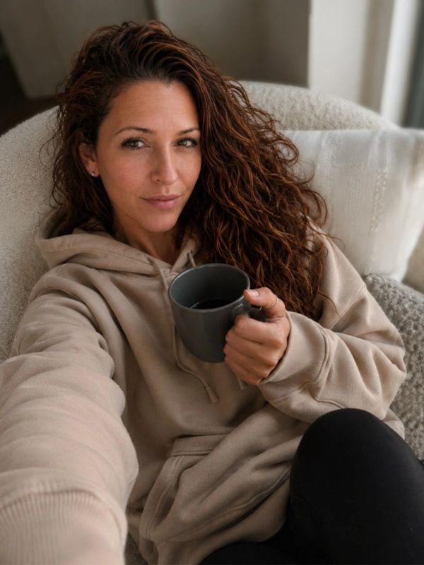 Australian author Ajay Howarth relaxing with coffee in her home office