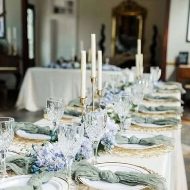 Elegant dining table with crystal glasses and floral centerpiece.