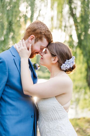 A bride and groom share an intimate moment outdoors.