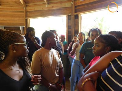 Group of people engaged in a discussion indoors.