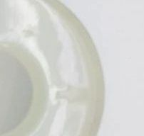 Close-up of a white circular object with a small notch.