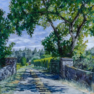 Entrance gate with a gravel driveway, a tree casts shadows across the road