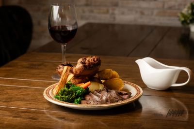 Traditional roast dinner with wine and gravy.