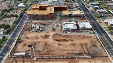 A construction site with buildings and cleared land.