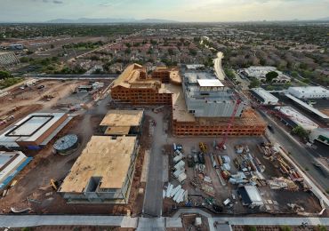 Aerial view of a large construction site near a residential area.