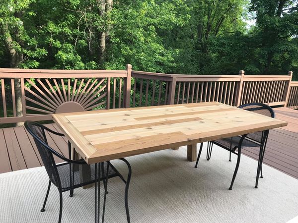 Cedar outdoor dining table with hairpin legs. Clear finish to show the beauty of the wood.