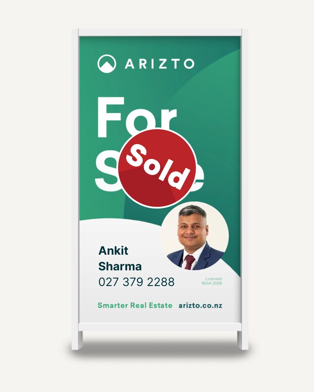 Real estate sign with a Sold sticker and agent Ankit Sharma contact info.