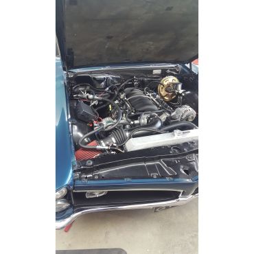 Classic car engine bay with modern V8 engine.