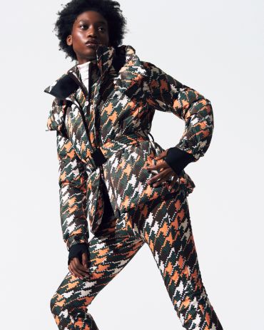Model in a bold patterned jacket and pants.