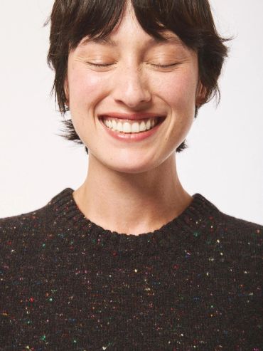 A person smiling with eyes closed.