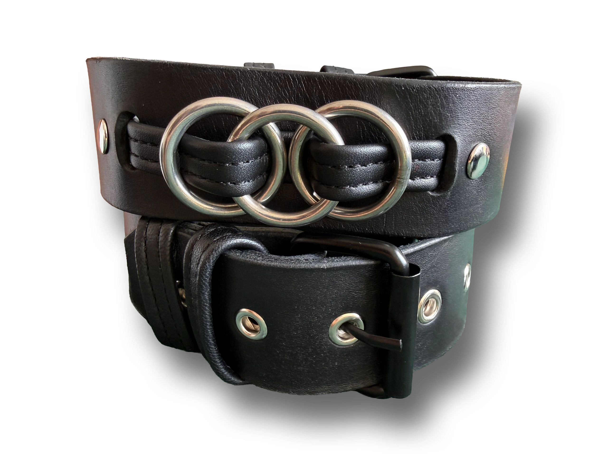 Close-up of the Onyrium black leather armband rolled up, with interlocking metal rings.