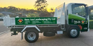 Landscaping company truck parked at sunset.