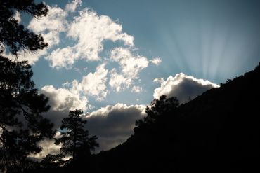 clouds, mountains, and rays of sunshine