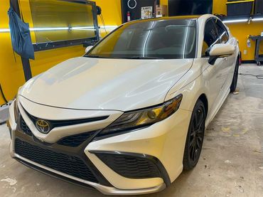 Picture of a 2024 Toyota Camry after we installed XPEL window tint on it at our shop in Fort Pierce