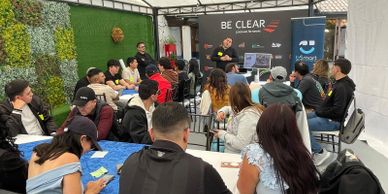 A group attending a presentation in a casual indoor setting.