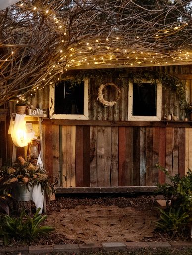 Rustic barn decorated with fairy lights for a wedding ceremony 