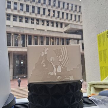 3D printed relief of a historical moment with raised fists and an American flag.