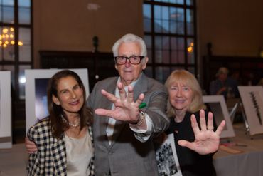 Photographer Harry Benson, with his wife, and Jessica Wannamaker at a NYC charity auction.