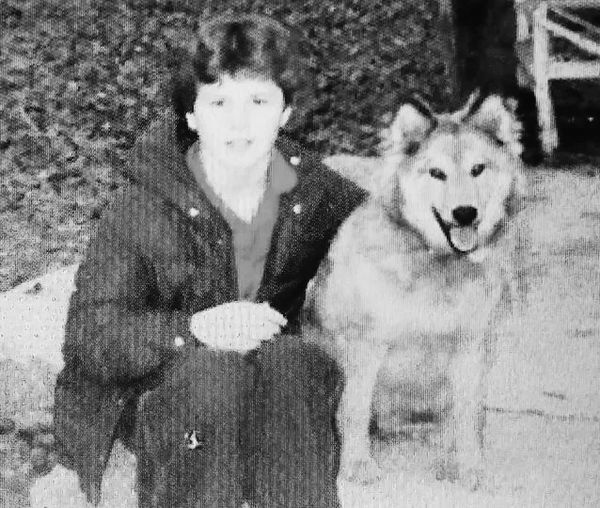 Dog next to person.