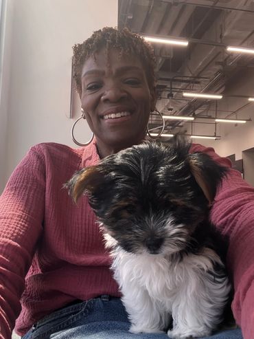 Smiling woman with small black and white dog.