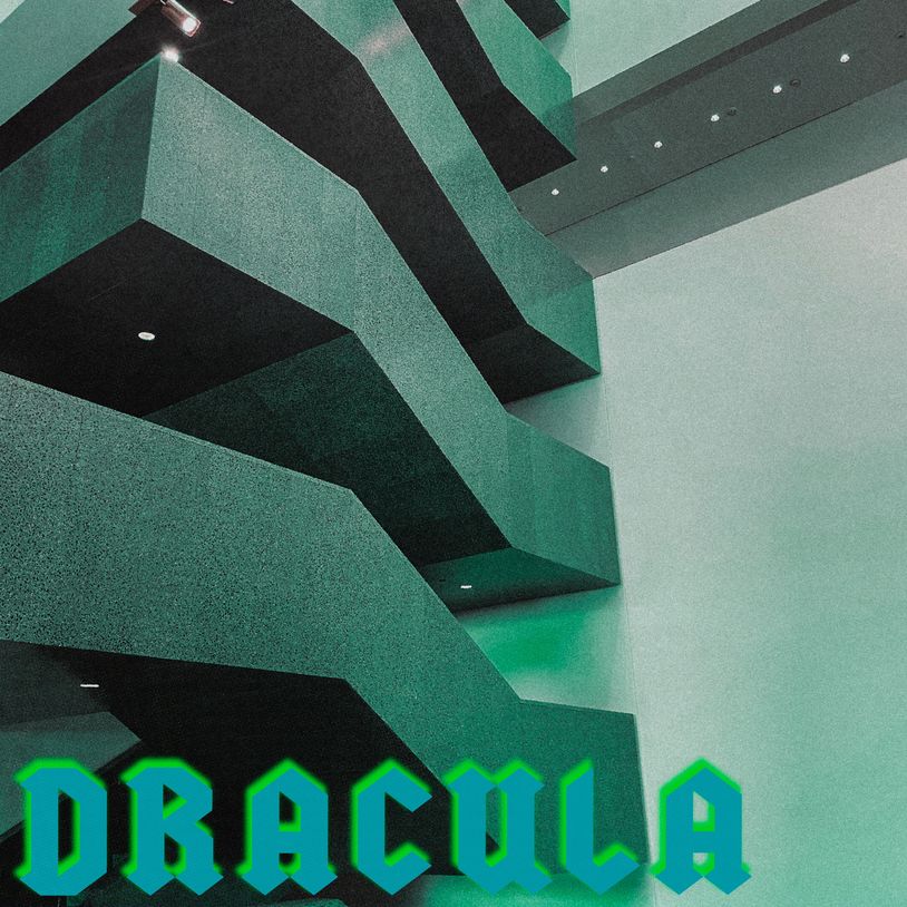Geometric interior with green stairs and Dracula text.
