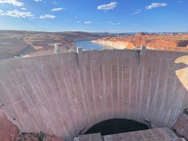 Large concrete dam with water reservoir.