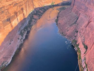 A winding river flowing between tall, rocky cliffs.
