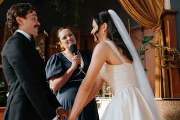 Bride and groom holding hands during a wedding ceremony.