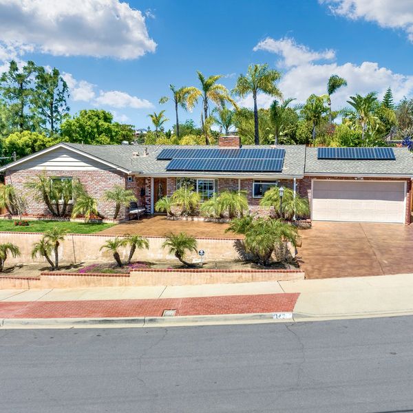 Real Estate Photo of a brick home with bronze colored stamped concrete front driveway