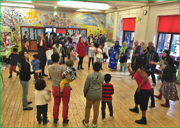 a circle of people of all ages and ethnicities take part in celebrations for Black History Month