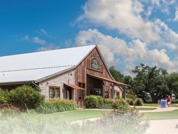 Rustic visitor center with a white roof on a sunny day.
