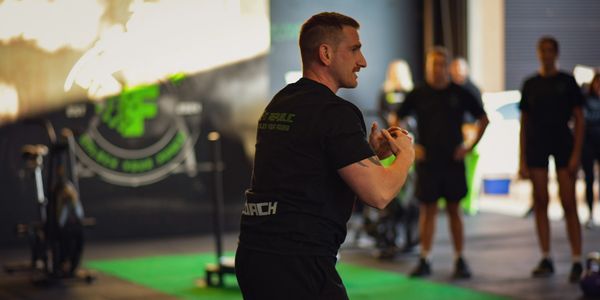 Coach leading the warm up in the gym. 