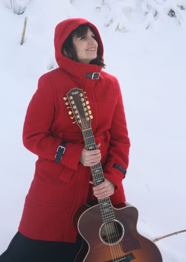 Sandy Lusco Playing an Acoustic Guitar