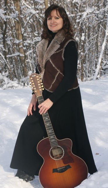 Sandy Lusco Playing an Acoustic Guitar