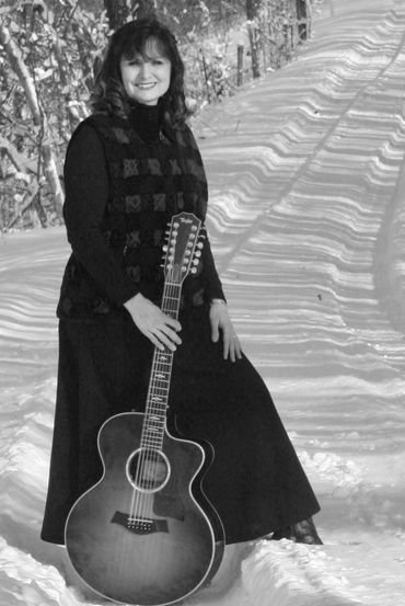 Sandy Lusco Playing an Acoustic Guitar