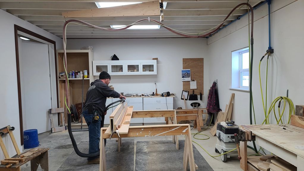 Person working with wood in a workshop.