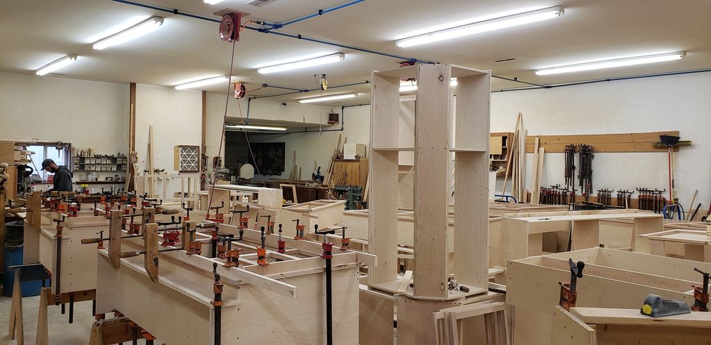 Woodshop filled with wooden projects and clamps.