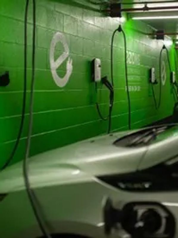 Level 2 EV chargers on a parking garage wall.