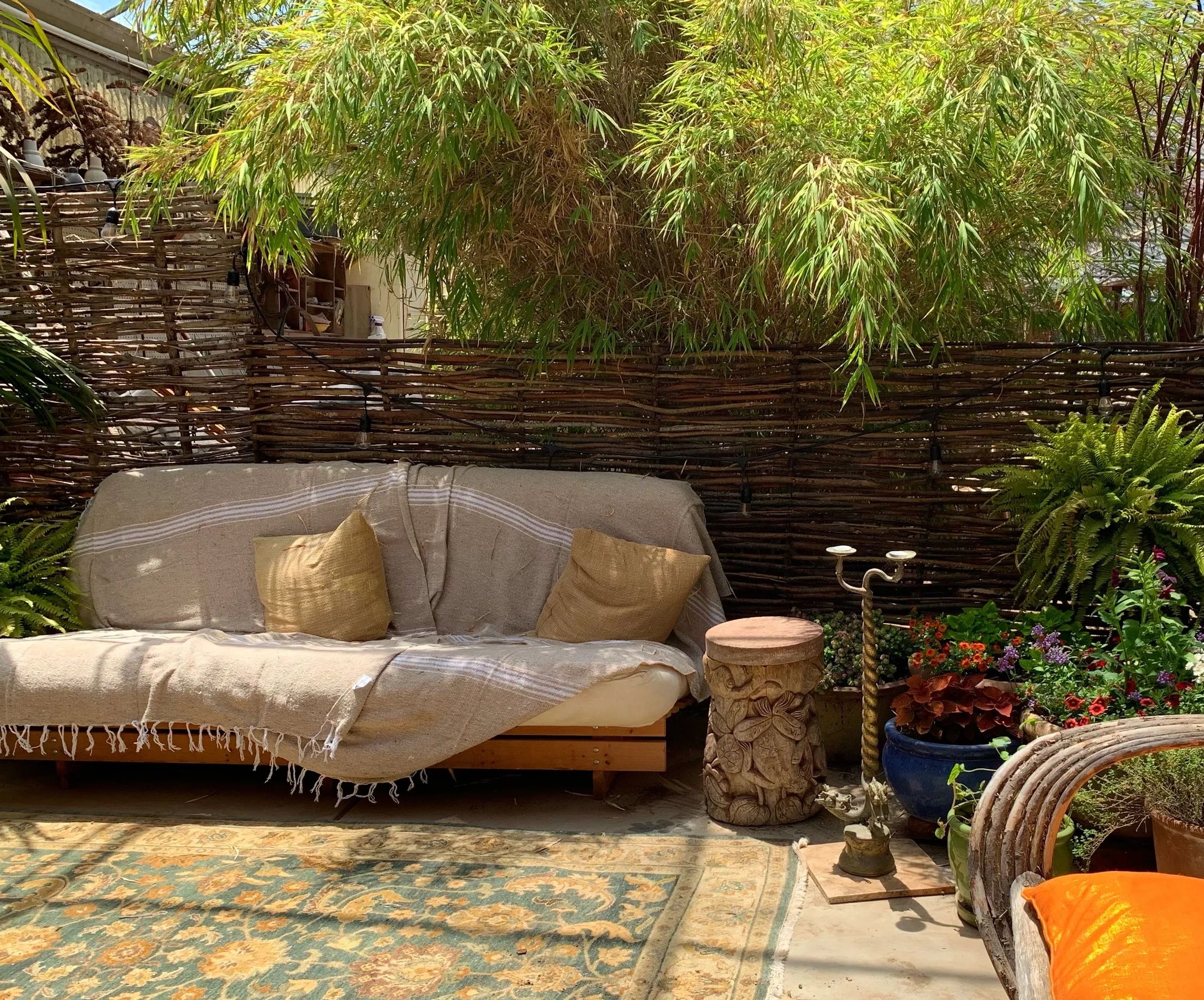 a cozy seating area inside a greenhouse