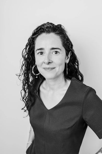 Black and white portrait of a woman with curly hair.